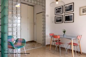 a dining room with a table and chairs at Casa DiMondi in Bologna +77 photos