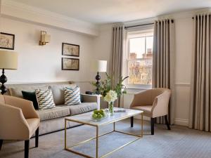 a living room with a couch and a table at Collingham Serviced Apartments in London
