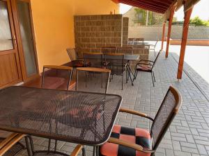 a group of tables and chairs on a patio at Penzion Trödler in Brod nad Dyjí