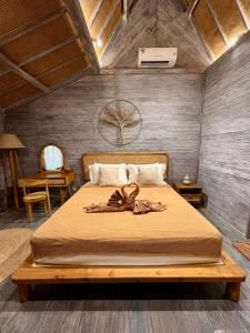 a bedroom with a large bed with a wooden frame at Twinseas Villa in Uluwatu +135 photos
