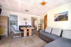a living room with a couch and a table at Ferienhaus Krawulski in Hohnstein