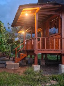 a house with a large deck with a light on it at SleepHere Homestay in Bayan