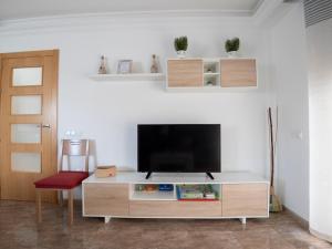 a living room with a flat screen tv on a white wall at Villa Joan in Riumar