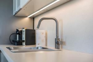 a kitchen sink with a faucet on a counter at Hof am Ammersee in Pähl +24 photos