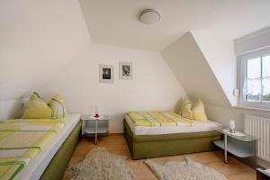 a bedroom with two beds and a window at Ferienhaus Krawulski in Hohnstein
