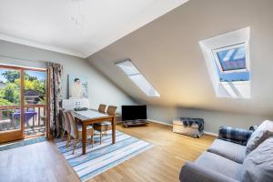 a living room with a couch and a table at Hof am Ammersee in Pähl