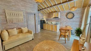 a living room with a couch and a table at Twinseas Villa in Uluwatu