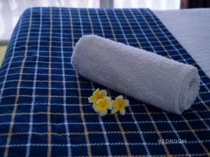 a roll of toilet paper and two flowers on a table at The Clifftop Home in Esperanza +46 photos