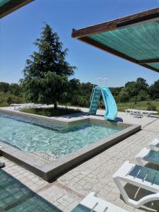 a swimming pool with a slide in the middle at A-Apartment in Krasnovo