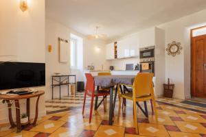 a kitchen and dining room with a table and chairs at Charmante Maison Vallon pont d'Arc in Vallon-Pont-dʼArc