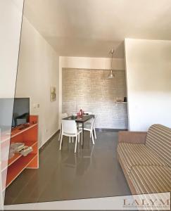 a kitchen and dining room with a table and chairs at Lalym Donnanna Apartment in Rossano Stazione