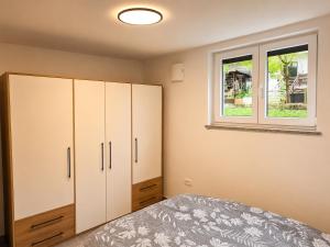 a bedroom with a bed and a window at Apartment Beli in Radovljica