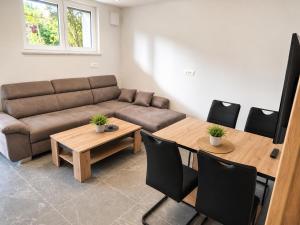 a living room with a couch and a table at Apartment Beli in Radovljica +4 photos