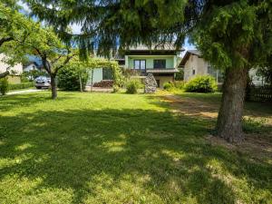 a house with a tree in the yard at Apartment Beli in Radovljica