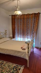 a bedroom with a bed with a chandelier at Casa do Vicente in Tabuaço