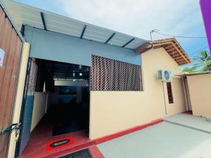 a building with a door open to a garage at Gulf Villa in Kattankudi