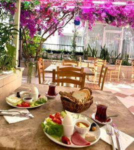 a table with plates of food on top at Kale Otel Bodrum in Bodrum City