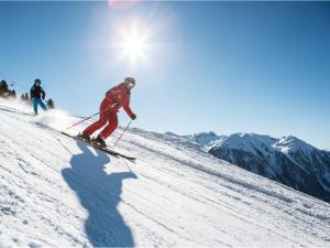two people skiing down a snow covered slope at Haus Dorothee in Sautens