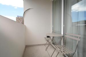 a balcony with a small table and a window at Chic city apartment I By Domel Yerevan in Yerevan