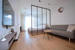 a living room with a couch and a table at Chic city apartment I By Domel Yerevan in Yerevan +44 photos