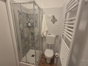 a bathroom with a toilet and a glass shower at Affittacamere Le Fontane in Altopascio +5 photos