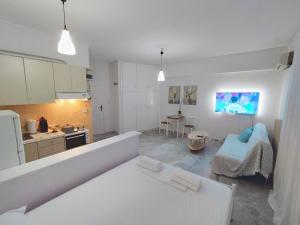 a kitchen and a living room with a couch at Cucuvaya Rithy in Áyios Andónios