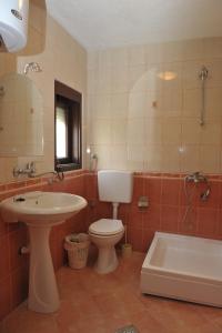 a bathroom with a sink and a toilet and a tub at Villa Marija in Struga +53 photos