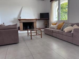 a living room with a couch and a fireplace at Casa Crystallia in Chalkida