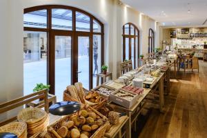 a long row of tables with bread and baskets at Amedia Plaza Dresden in Dresden
