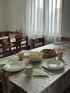 a table with plates and bowls of food on it at Etno village Bare in Bare