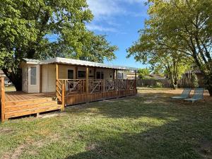 a tiny house with a deck and a porch at My Maui Home in Salles
