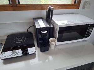 a kitchen counter with a microwave and a toaster oven at Luna Studio in Apia