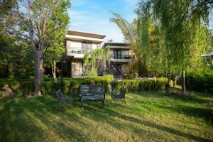 a yard with a bench in front of a house at The Golden Tusk By Ivory Destinations in Rāmnagar