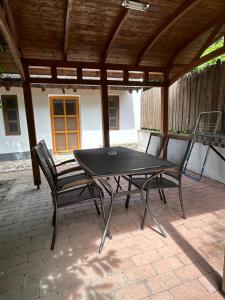 a black table and two chairs on a patio at Mézes-Kuckó in Tihany +6 photos