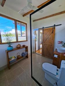 a bathroom with a toilet and a glass shower door at Luna Studio in Apia +8 photos
