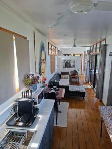 a living room with a kitchen and a living room with a couch at Luna Studio in Apia