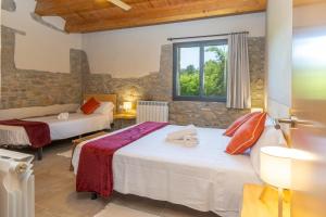 a room with two beds and a window at Mas Ca la Rossa in Girona +24 photos