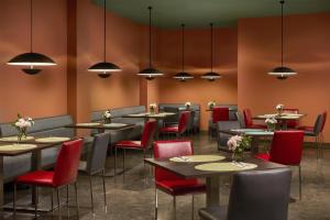a restaurant with tables and chairs and lights at NH Barcelona Diagonal Poblenou in Barcelona +23 photos