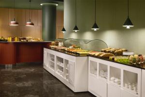 a buffet line with many different types of food at NH Barcelona Diagonal Poblenou in Barcelona