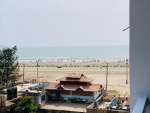a view of a beach with people on the beach at The Sea Princess Hotel in Cox's Bazar
