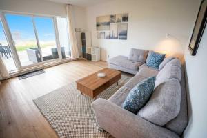 a living room with a couch and a table at Luxury Condo with Stunning View and Pool in Baie-Saint-Paul +44 photos