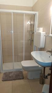 a bathroom with a shower and a toilet and a sink at Locanda El Piron in Chiampo +17 photos