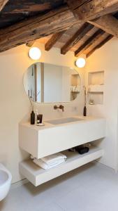 a bathroom with a white sink and a mirror at Suite Los Arcos in Chioggia +14 photos