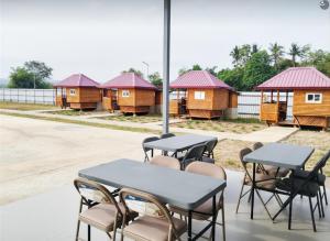 a table and chairs with a row of houses at Villa Cedes in Lasam