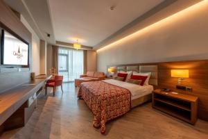 a hotel room with a bed and a desk at Grand Asya Hotel in Bandırma +73 photos