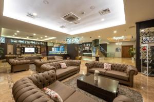 a large living room with couches and a television at Grand Asya Hotel in Bandırma