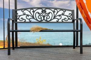 a bench on a deck with a view of the ocean at Donghae aeodalari pension in Donghae +4 photos