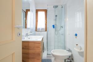 a bathroom with a shower and a toilet and a sink at Villetta Pineta in Santa Margherita di Pula +22 photos