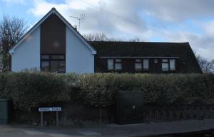 a house with a street sign in front of it at Bay Lodge in Birchington