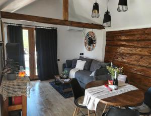 a living room with a couch and a table at Casa33 in Dobrovnik